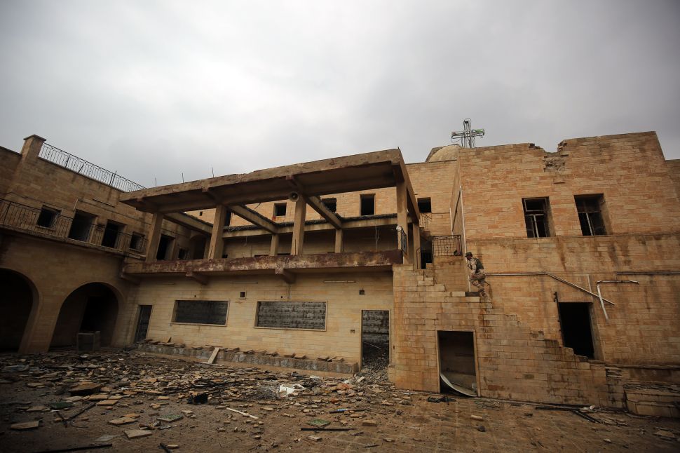 An Iraqi soldier inspects the debris at St. George's Monastery, a historical Chaldean Catholic church, in Mosul, which was destroyed by Islamic State (IS) group in 2015.