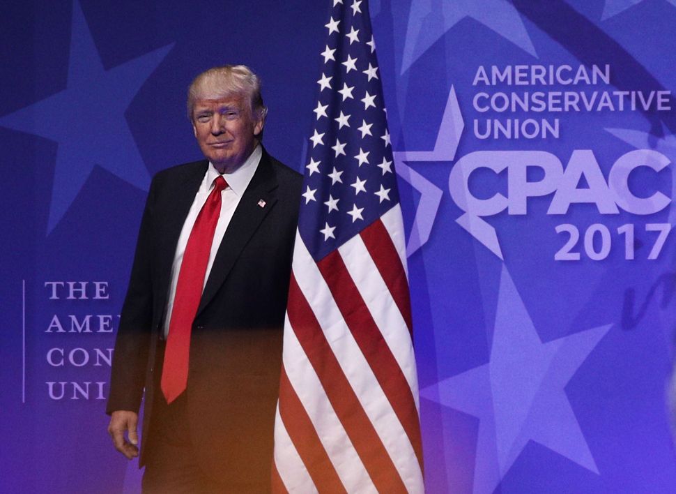 President Donald Trump walks on stage to address CPAC on February 24, 2017.