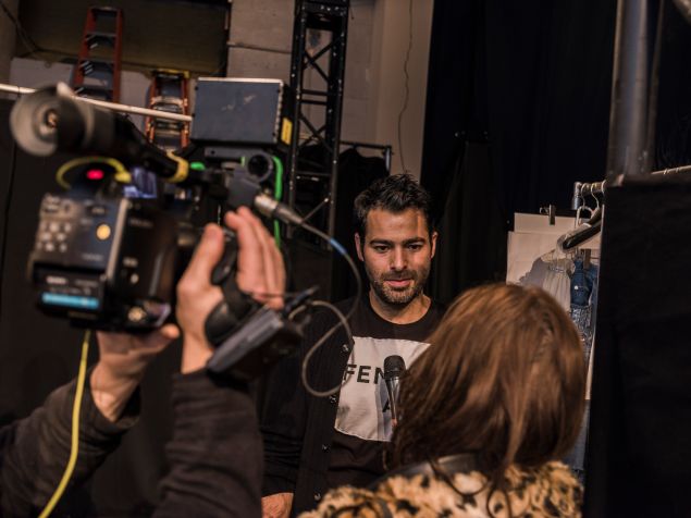 Jonathan Simkhai in interview mode at his fashion show.
