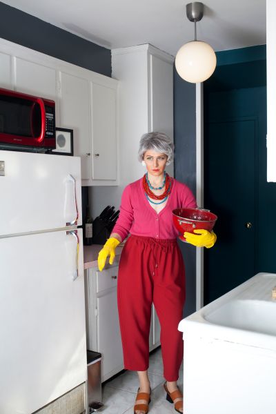 Kaufman in the kitchen, wearing Suzanne Rae.