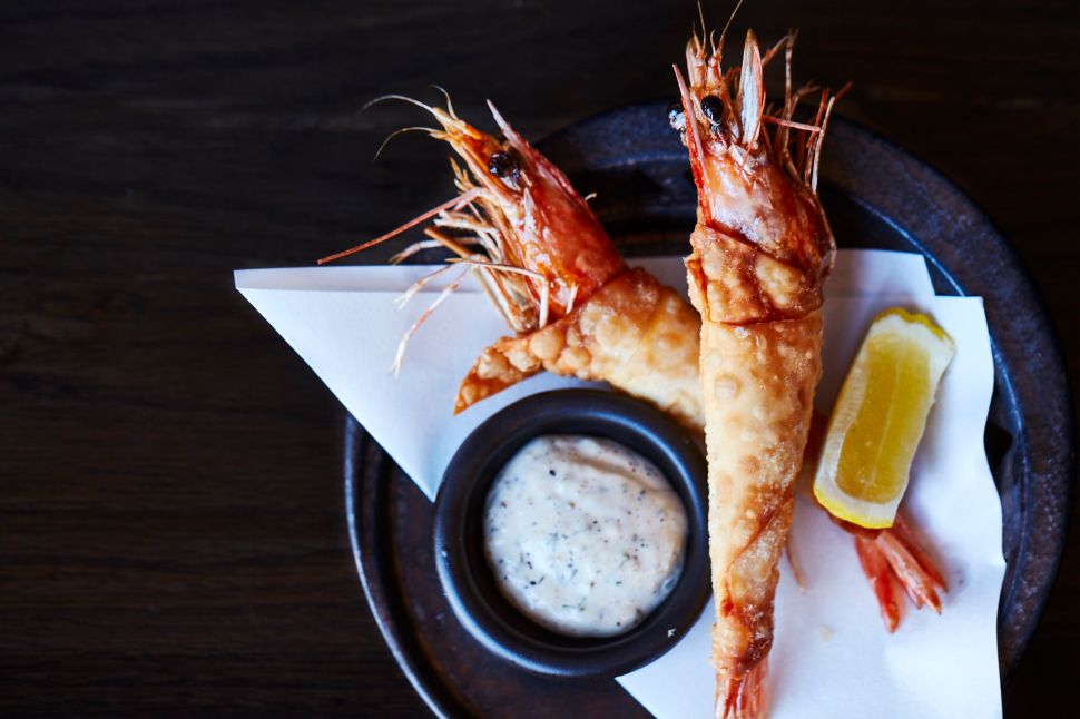 Head-on prawns are fried in a spring-roll batter.
