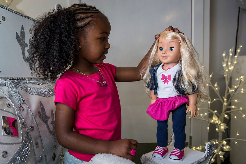 LONDON, ENGLAND - JUNE 26: Jayla, aged 4, plays with a 'My Friend Cayla' doll in the Hamleys toy shop on June 26, 2014 in London, England. The doll, which uses Bluetooth technology to connect to Android and iOS devices, retails for 75 GBP and is included in Hamleys' predictions for the top selling toys for Christmas 2014. (Photo by Rob Stothard/Getty Images)