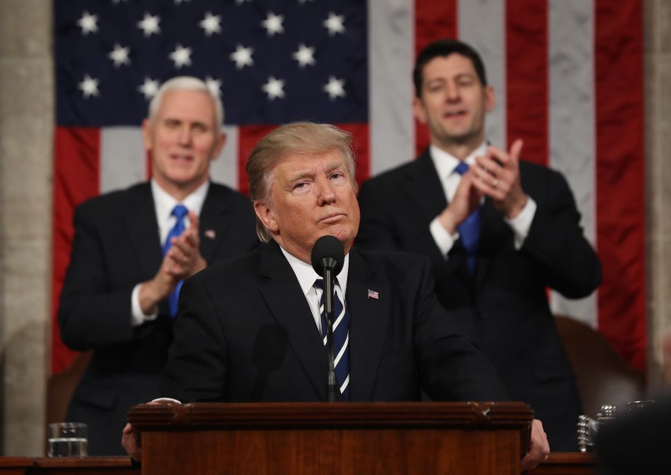 WASHINGTON, DC - FEBRUARY 28: (AFP OUT) U.S. Vice President Mike Pence (L) and Speaker of the House Paul Ryan (R) applaud after U.S. President Donald J. Trump (C) delivers his first address to a joint session of the U.S. Congress on February 28, 2017 in the House chamber of the U.S. Capitol in Washington, DC. Trump's first address to Congress focused on national security, tax and regulatory reform, the economy, and healthcare.