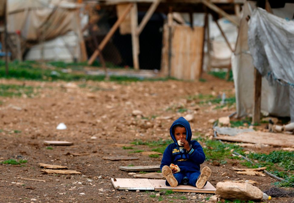 A Bedouin child plays in the Palestinian Bedouin village of Khan al-Ahmar, in the Israeli-occupied West Bank, during a visit of the Palestinian prime minister on March 2, 2017. The United Nations raised concerns last month over newly announced demolition plans in the Palestinian Bedouin village that threaten dozens of buildings including a primary school. / AFP PHOTO / ABBAS MOMANI