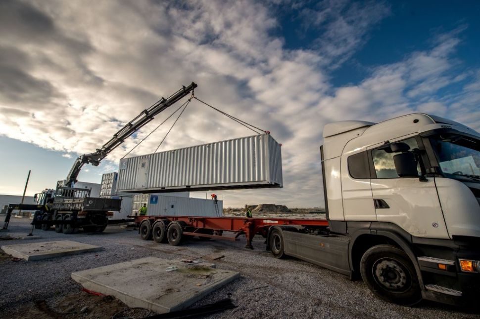 Workers use a crane to dismantle the "Provisional Reception Center" (CAP, Centre d'Acceuil Provisoire), containers installed by the government to house up to 1500 migrants, at the former "Jungle" migrant camp in Calais on February 14, 2017. The camp was closed in October 2016. / AFP / PHILIPPE HUGUEN (Photo credit should read PHILIPPE HUGUEN/AFP/Getty Images)