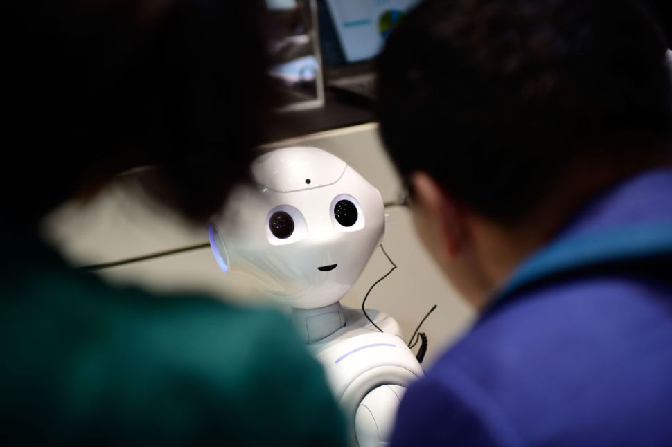 HANOVER, GERMANY - MARCH 20: The robot "Pepper" speaks with visitors at the IBM stand at the CeBIT 2017 Technology Trade Fair on March 20, 2017 in Hanover, Germany. "Pepper" has a face detection and is either used to greet Hotel guests during arrival or can be personalized by his owner to help in the household. The 2017 CeBIT will run from March 20-24. (Photo by Alexander Koerner/Getty Images)
