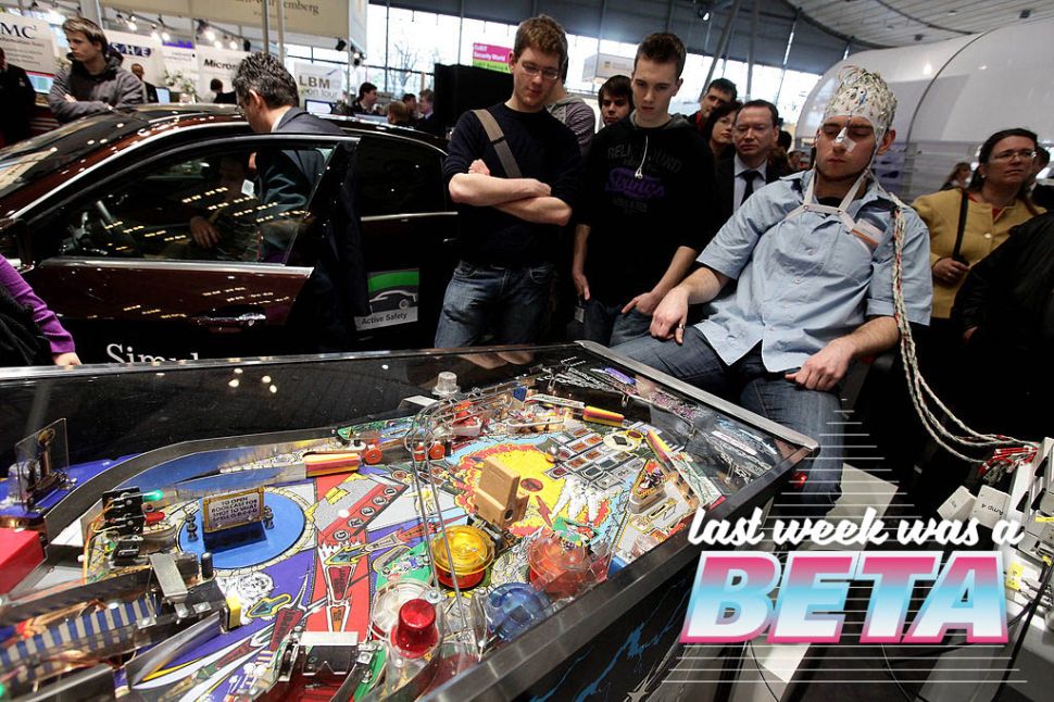HANNOVER, GERMANY - MARCH 02: A man, wearing an EEG brain scanning apparatus on his head, plays a pinball game solely through willing the paddles to react with his brain at the Berlin Brain Computer Interface research consortium stand at the CeBIT Technology Fair on March 2, 2010 in Hannover, Germany. CeBIT will be open to the public from March 2 through March 6. (Photo by Sean Gallup/Getty Images)