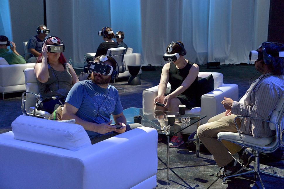 HOLLYWOOD, CA - SEPTEMBER 24: Attendees test out the first consumer version of the Samsung Gear VR at Oculus Connect 2 Developers Conference 2015 at Loews Hollywood Hotel on September 24, 2015 in Hollywood, California. (Photo by Charley Gallay/Getty Images for Samsung)