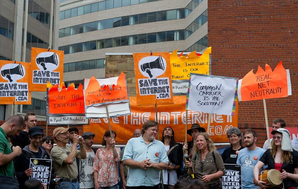 Protesters hold a rally to support "net neutrality" and urge the Federal Communications Commission (FCC) to reject a proposal that would allow Internet service providers such as AT&T and Verizon "to boost their revenue by creating speedy online lanes for deep-pocketed websites and applications and slowing down everyone else," on May 15, 2014 at the FCC in Washington, DC. The FCC commissioners voted on a proposal for protecting an open Internet. AFP PHOTO / Karen BLEIER (Photo credit should read KAREN BLEIER/AFP/Getty Images)