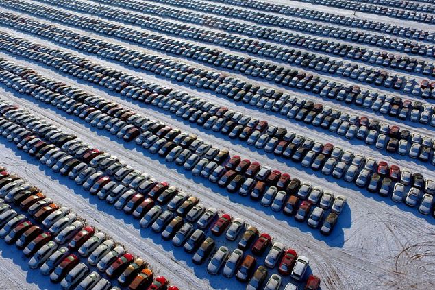 This aerial photo taken on January 16, 2017 shows new cars lined up at a parking lot in Shenyang, northeast China's Liaoning province. Auto sales in China, the world's biggest car market, surged at their fastest in three years in 2016, an industry group showed on January 12, jumping nearly 14 percent after authorities slashed a purchase tax. / AFP / STR / China OUT (Photo credit should read STR/AFP/Getty Images)