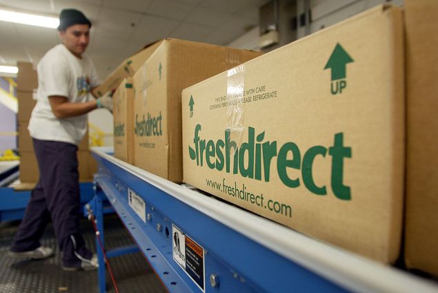 NEW YORK - DECEMBER 5: A worker shepherds finished grocery boxes ready for delivery at the new FreshDirect online grocery service warehouse December 5, 2002 in New York City. The state-of-the-art 300,000 square foot facility houses 200 workers with a fleet of 23 trucks making deliveries based on 2-hour appointment slots to New Yorkers. FreshDirect charges a flat $3.95 delivery fee. In an era of failed Web businesses, FreshDirect owner Joe Fedele says he hopes to turn a profit in six months. (Photo by Mario Tama/Getty Images)