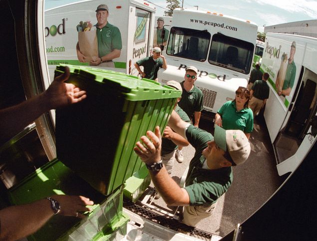 Several Peapod workers unload containers of groceries from the back of their truck July 12, 2000 in Chicago. Peapod, an online grocery supermarket, plans to upgrade their web site with new technology to improve services, the company told shareholders. (Photo by Tim Boyle/Getty Images)