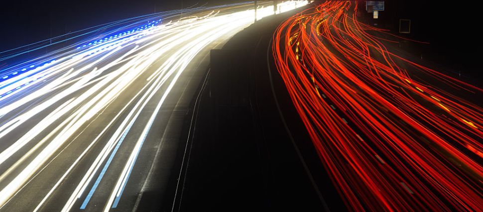 Picture taken with long time exposure shows light traces of cars driving on the A2 highway at the connection 'Lehrte' near Hanover, central Germany, on January 17, 2017. / AFP / dpa / Julian Stratenschulte / Germany OUT (Photo credit should read JULIAN STRATENSCHULTE/AFP/Getty Images)
