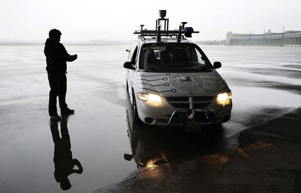 Researcher Tinosch Ganjineh drives the "Spirit of Berlin", an autonomous car, with an iPhone, using a wifi connection, at Berlin's Templehof airport November 2, 2009. The Spirit of Berlin is a project of the Artificial Intelligence Group, directed by Rojas, at Berlin's Freie Universitaet. AFP PHOTO JOHN MACDOUGALL (Photo credit should read JOHN MACDOUGALL/AFP/Getty Images)