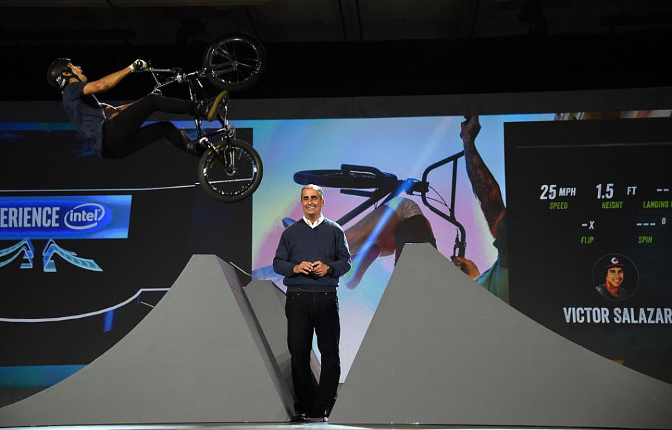LAS VEGAS, NV - JANUARY 05: BMX rider Victor Salazar jumps over Intel Corp. CEO Brian Krzanich on a bike fitted with Intel Curie chips in the handlebars and seat during Krzanich's keynote address at CES 2016 at The Venetian Las Vegas on January 5, 2016 in Las Vegas, Nevada. Sensors recording the jump displayed data on a screen in real time to demonstrate how the technology can be used for sports television coverage. CES, the world's largest annual consumer technology trade show, runs from January 6-9 and is expected to feature 3,600 exhibitors showing off their latest products and services to more than 150,000 attendees. (Photo by Ethan Miller/Getty Images)