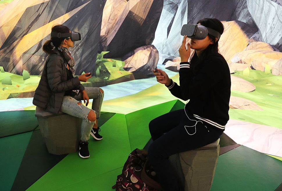 NEW YORK, NY - OCTOBER 20: Women try the Google Daydream VR at the new Google pop-up shop in the SoHo neighborhood on October 20, 2016 in New York City. The shop lets people try out new Google products such as the Pixel phone, Google Home, and Daydream VR. The products will be available for purchase offsite at Verizon and Best Buy retail stores. (Photo by Spencer Platt/Getty Images)