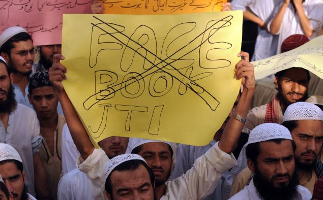 Pakistani Muslims shout slogans and wave placards as they protest against Facebook in Lahore on May 26, 2010. Pakistan is to lift a ban on Facebook and YouTube in the next few days, after blocking the websites over "sacrilegious" content, the country's interior minister said. When a Facebook user decided to organise an "Everyone Draw Mohammed Day" competition to promote "freedom of expression", it sparked a major backlash among Islamic activists in the South Asian country of 170 million. Islam strictly prohibits the depiction of any prophet as blasphemous and the row sparked comparison with protests across the Muslim world over the publication of satirical cartoons of Mohammed in European newspapers in 2006. AFP PHOTO/Arif ALI (Photo credit should read Arif Ali/AFP/Getty Images)