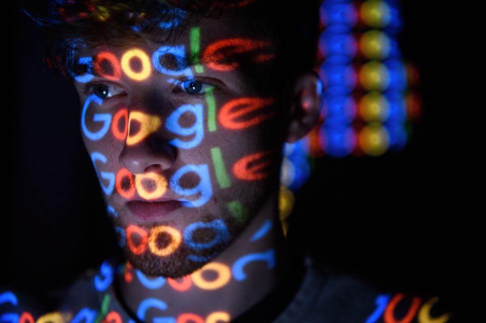 LONDON, ENGLAND - AUGUST 09: In this photo illustration, The Google logo is projected onto a man on August 09, 2017 in London, England. Founded in 1995 by Sergey Brin and Larry Page, Google now makes hundreds of products used by billions of people across the globe, from YouTube and Android to Smartbox and Google Search. (Photo by Leon Neal/Getty Images)