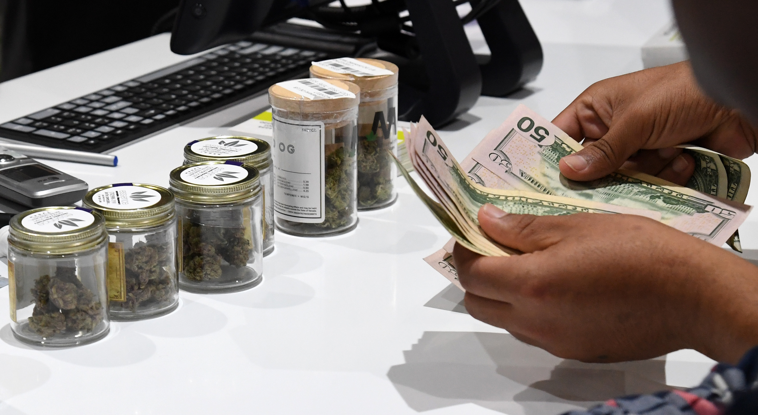 LAS VEGAS, NV - JULY 01: A customer pays for cannabis products at Essence Vegas Cannabis Dispensary after the start of recreational marijuana sales began on July 1, 2017 in Las Vegas, Nevada. Nevada joins seven other states allowing recreational marijuana use and becomes the first of four states that voted to legalize recreational sales in November's election to allow dispensaries to sell cannabis for recreational use to anyone over 21. (Photo by Ethan Miller/Getty Images)