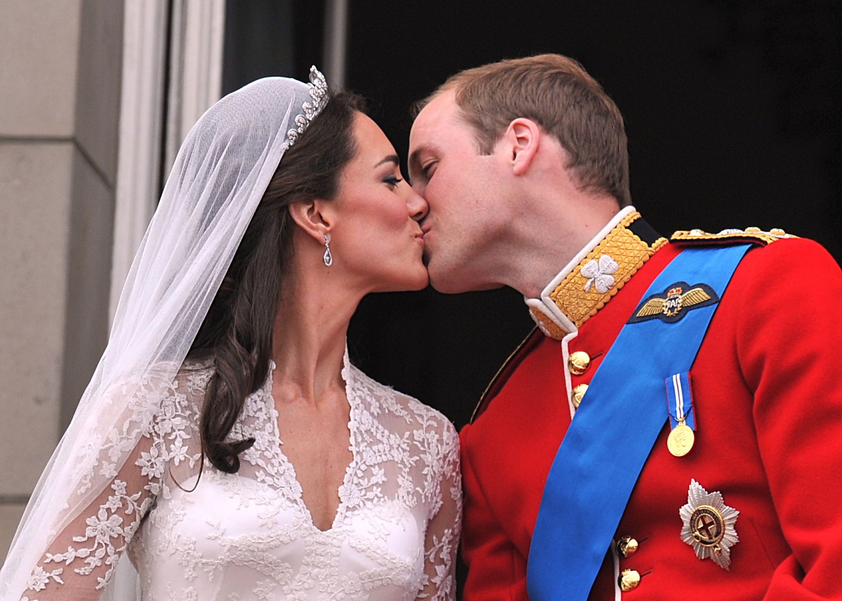LONDON, ENGLAND - APRIL 29: Their Royal Highnesses Prince William, Duke of Cambridge and Catherine, Duchess of Cambridge kiss on the balcony at Buckingham Palace during the Royal Wedding of Prince William to Catherine Middleton on April 29, 2011 in London, England. The marriage of the second in line to the British throne was led by the Archbishop of Canterbury and was attended by 1900 guests, including foreign Royal family members and heads of state. Thousands of well-wishers from around the world have also flocked to London to witness the spectacle and pageantry of the Royal Wedding. 