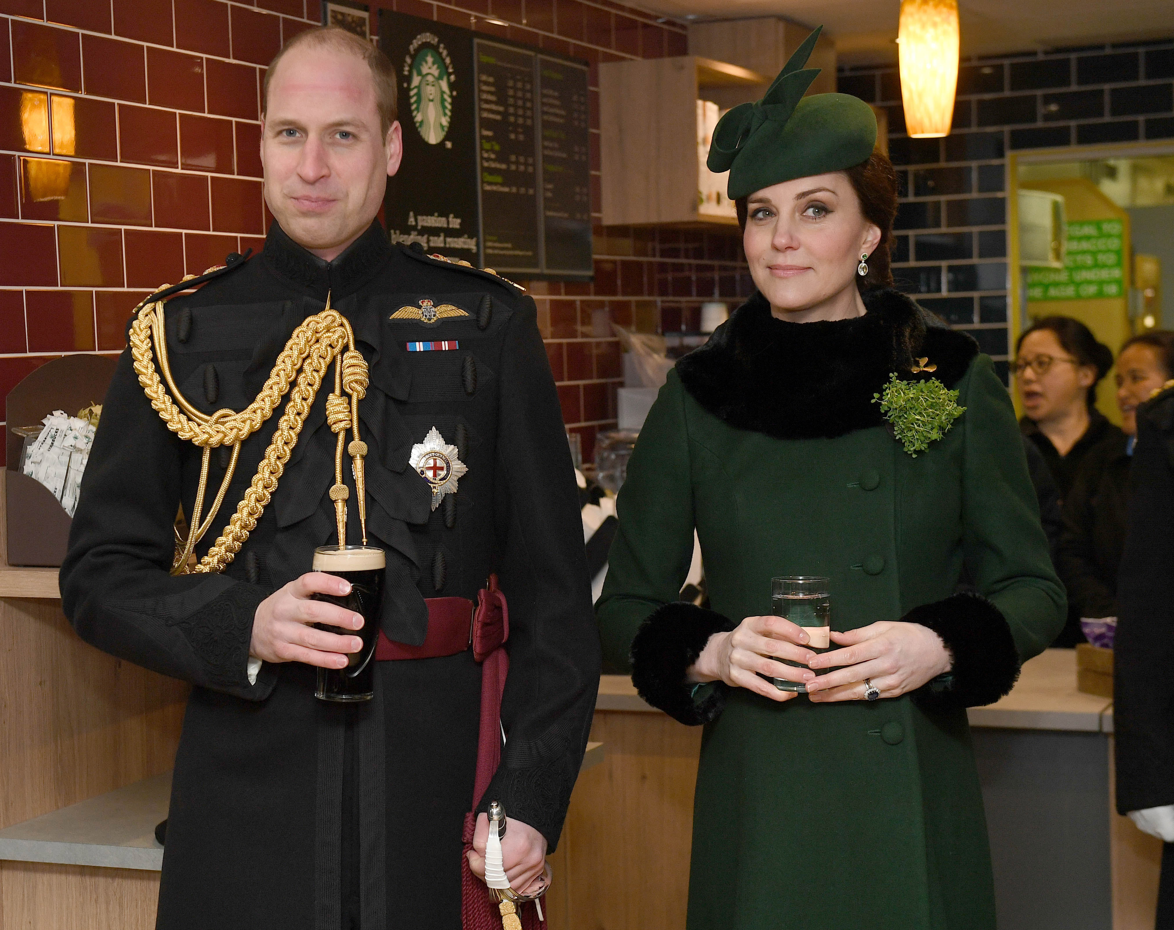 HOUNSLOW, ENGLAND - MARCH 17: Prince William, Duke Of Cambridge, Colonel of the Irish Guards drinks a pint of Guinness next to Catherine, Duchess of Cambridge as they attend the annual Irish Guards St Patrick's Day Parade at Cavalry Barracks on March 17, 2018 in Hounslow, England. (Photo by Andrew Parsons - WPA Pool/Getty Images)