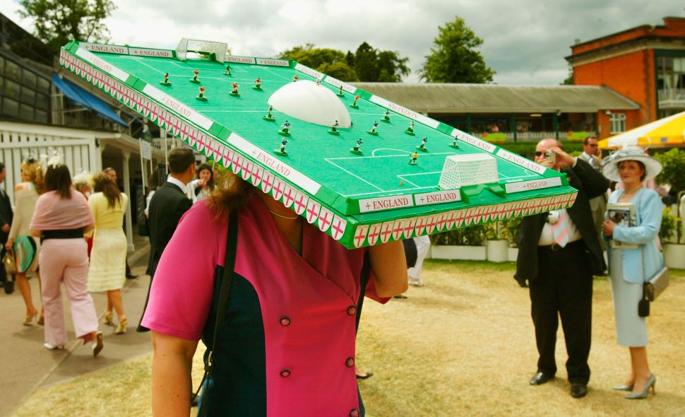 BERKSHIRE, ENGLAND - JUNE 17: An England supporter wears an extravagant hat in the shape of a mini football pitch during Ladies Day on the third day of Royal Ascot at the Ascot Racecourse on June 17, 2004 in Berkshire, England.