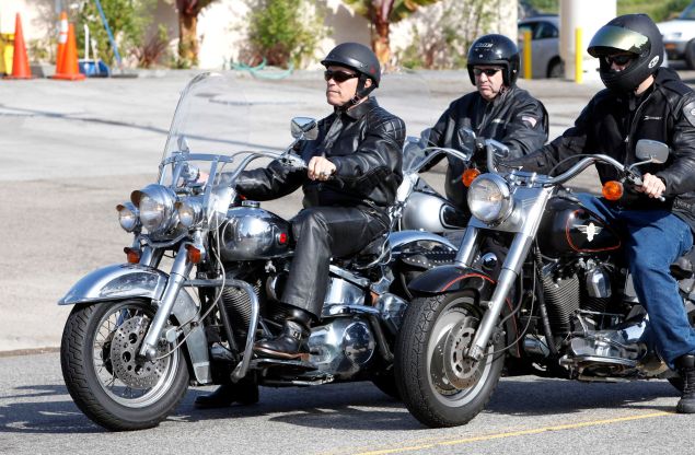 Arnold Schwarzenegger takes a ride on his all chrome Harley-Davidson.