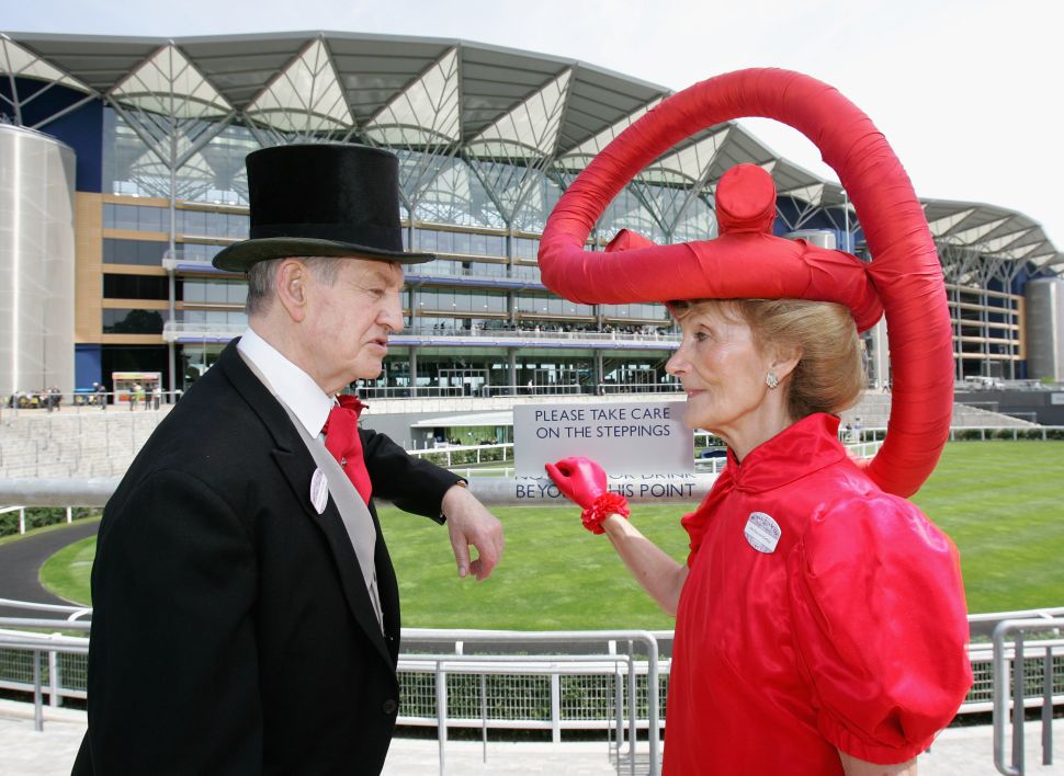 ASCOT, UNITED KINGDOM - JUNE 19: A lady in an elaborate hat talks to a man in a morning suit on the first day of Royal Ascot 2007 on June 19, 2007 in Ascot, England. (Photo by Chris Jackson/Getty Images)
