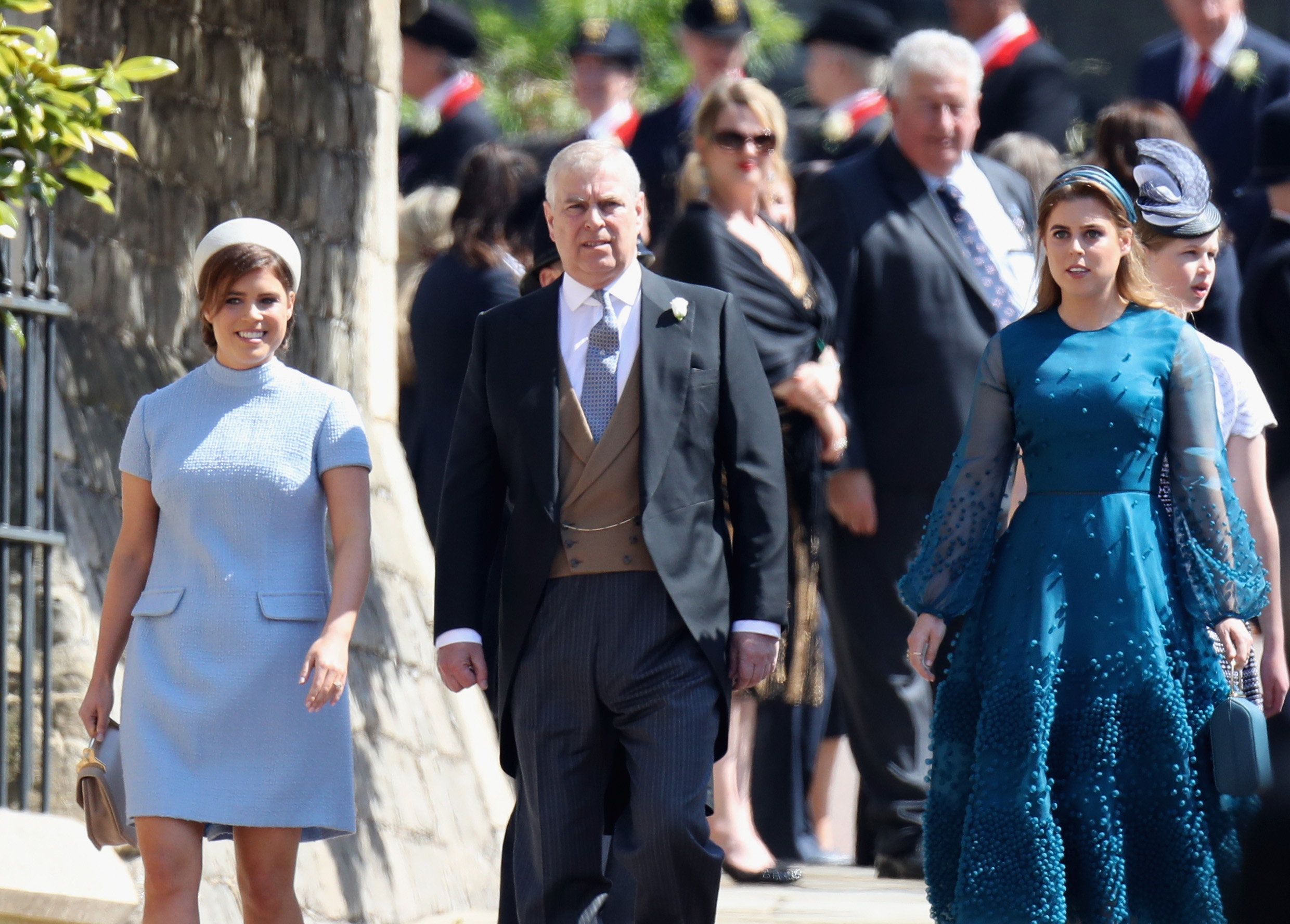 WINDSOR, ENGLAND - MAY 19: (L-R) Princess Eugenie, Prince Andrew, Duke of York and Princess Beatrice attend the wedding of Prince Harry to Ms Meghan Markle at St George's Chapel, Windsor Castle on May 19, 2018 in Windsor, England. Prince Henry Charles Albert David of Wales marries Ms. Meghan Markle in a service at St George's Chapel inside the grounds of Windsor Castle. Among the guests were 2200 members of the public, the royal family and Ms. Markle's Mother Doria Ragland.