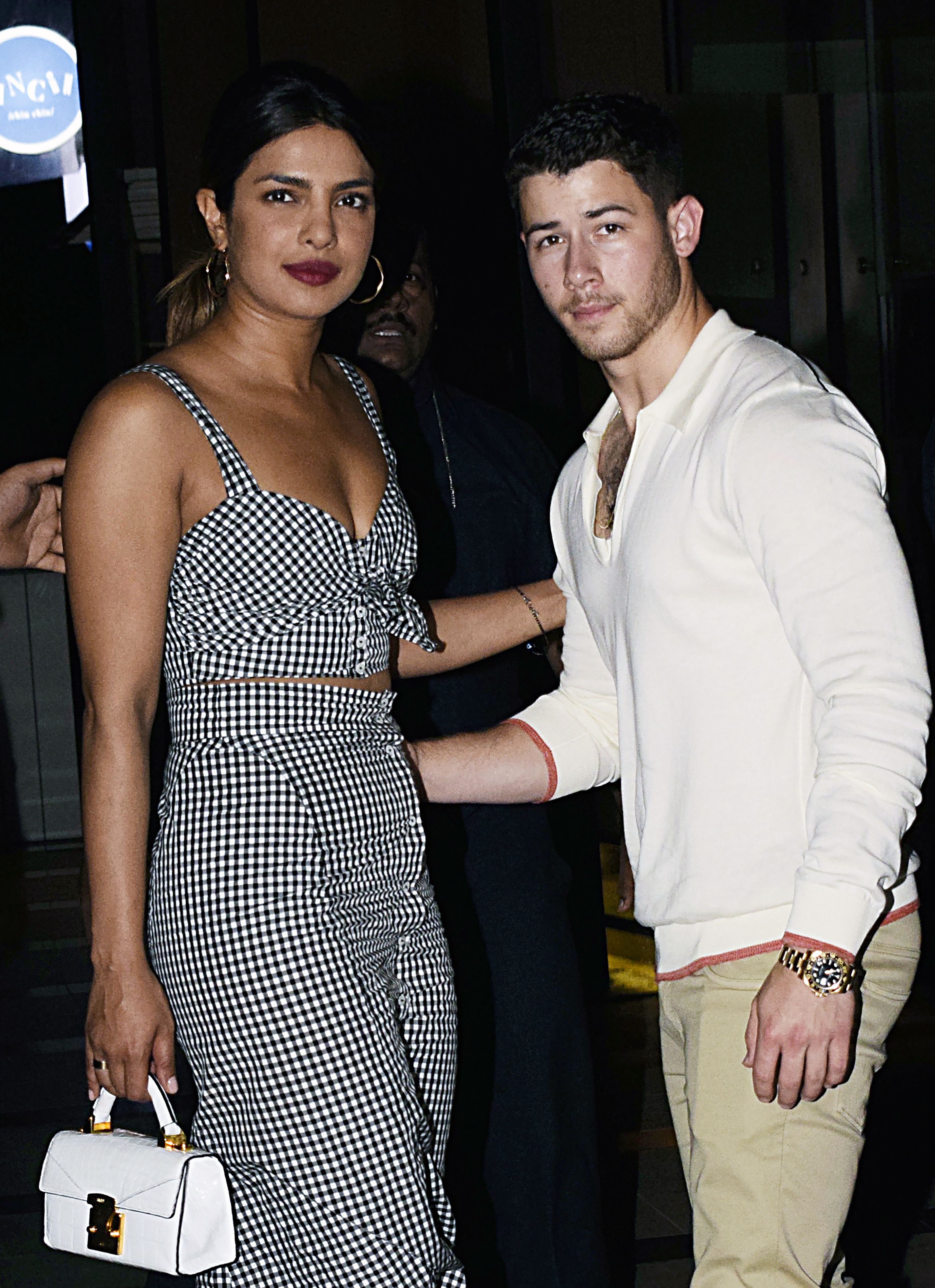 Indian Bollywood actress Priyanka Chopra (L) and US singer Nick Jonas (R) stand together in Mumbai on June 22, 2018.