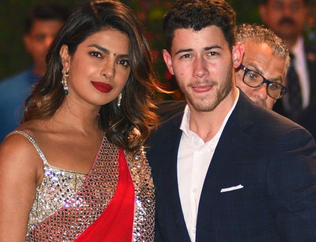Indian Bollywood actress Priyanka Chopra (L) accompanied by Nick Jonas arrive for the pre-engagement party of India's richest man and Reliance Industries Limited Chairman, Mukesh Ambanis eldest son Akash Ambani and fiancee Shloka Mehta in Mumbai on June 28, 2018.