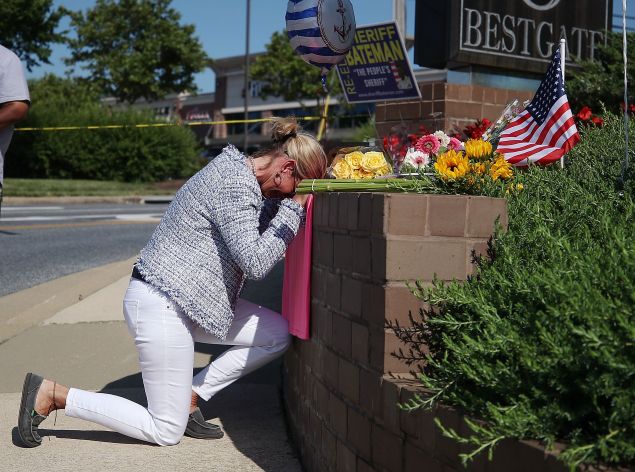 Lynne Griffin pays her respects at a makeshift memorial near the Capital Gazette where 5 people were shot and killed by a gunman on Thursday, on June 29, 2018 in Annapolis, Maryland. Griffin was a journalism student under John McNamara who was one of the people killed at the paper. Jarrod Ramos of Laurel Md. Has been arrested and charged with killing 5 people at the daily newspaper.