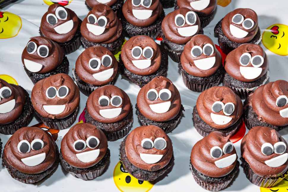 A display of poop emoji cupcakes 