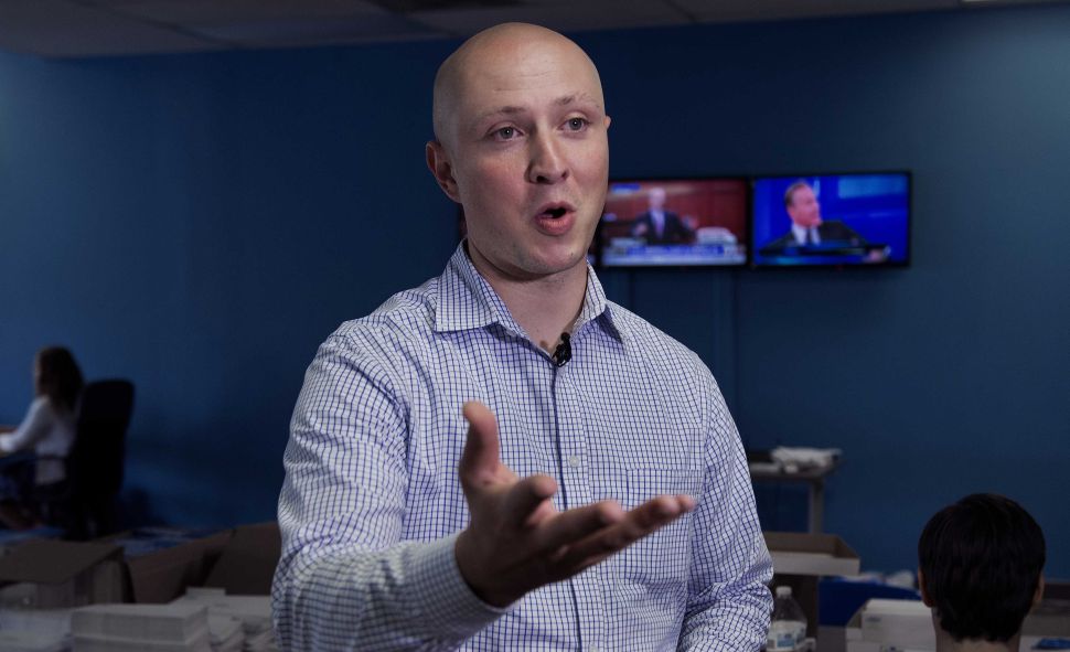 Adam J. Parkhomenko, Executive Director of the 'Ready For Hillary' Super PAC, working on behalf of undeclared US Presidential candidate and former US Secretary of State Hillary Clinton, is seen doing a TV interview July 11, 2013 at the PAC office in Alexandria, Virginia.