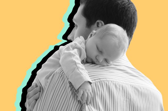 Father holds newborn on shoulder