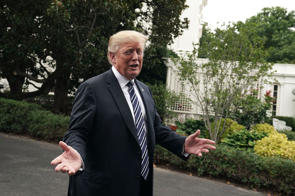 WASHINGTON, DC - JULY 23: (AFP OUT) U.S. President Donald Trump gestures to an exhibitor during the 2018 Made in America Product Showcase July 23, 2018 at the White House in Washington, DC. The White House held the showcase to "celebrates every state's effort and commitment to American-made products, and will allow these companies to speak with senior Administration officials, including the President, the Vice President, members of the Cabinet, and senior staff."
