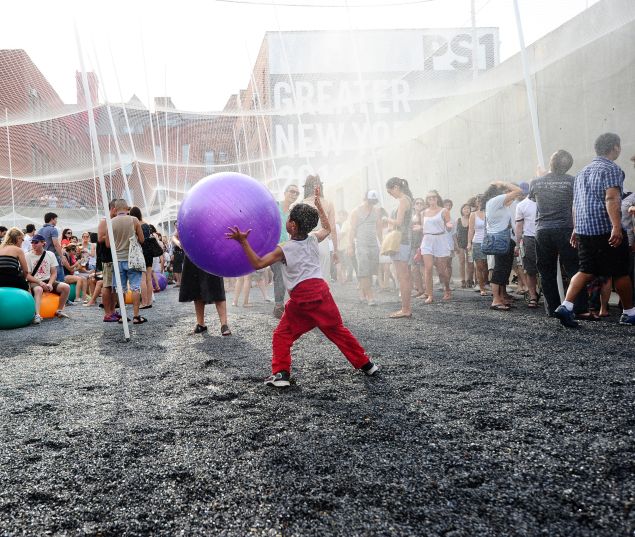 Children play under a fresh water sprinkler during a party at MoMA PS1.