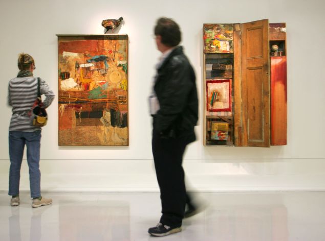 Visitors to the Centre Pompidou look at works Satellite and Interview by Robert Rauschenberg.
