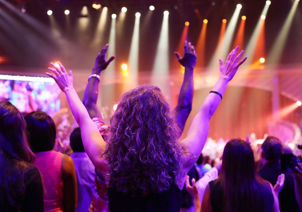 Parishioners of the Lakewood Church led by Pastor Joel Osteen pray together during a service at the church.
