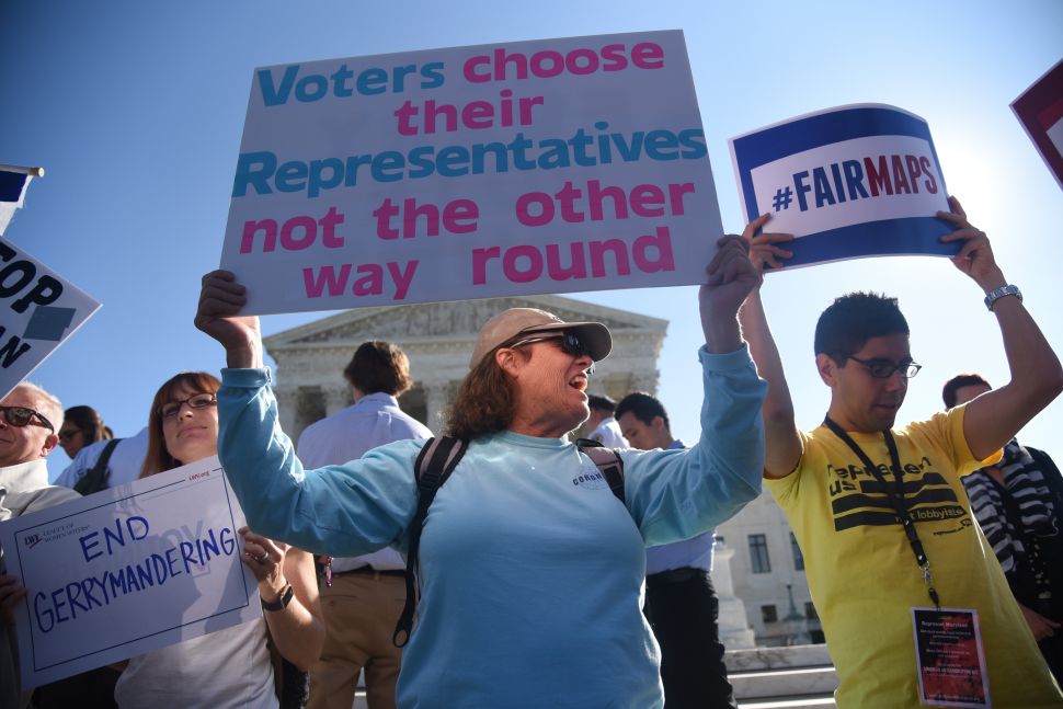 Demonstrators gather outside of the United States Supreme Court during an oral arguments in Gill v. Whitford to call for an end to partisan gerrymandering on October 3, 2017 in Washington, D.C.