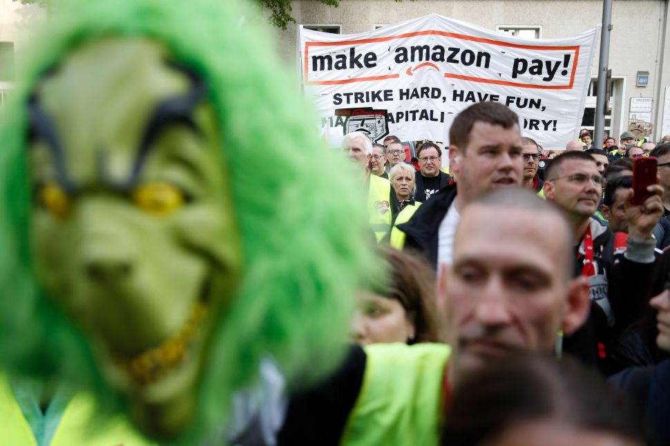 European Amazon employees, like these workers in Berlin, are protesting the company's working conditions during Prime Day. And for some reason, they brought the Grinch with them.