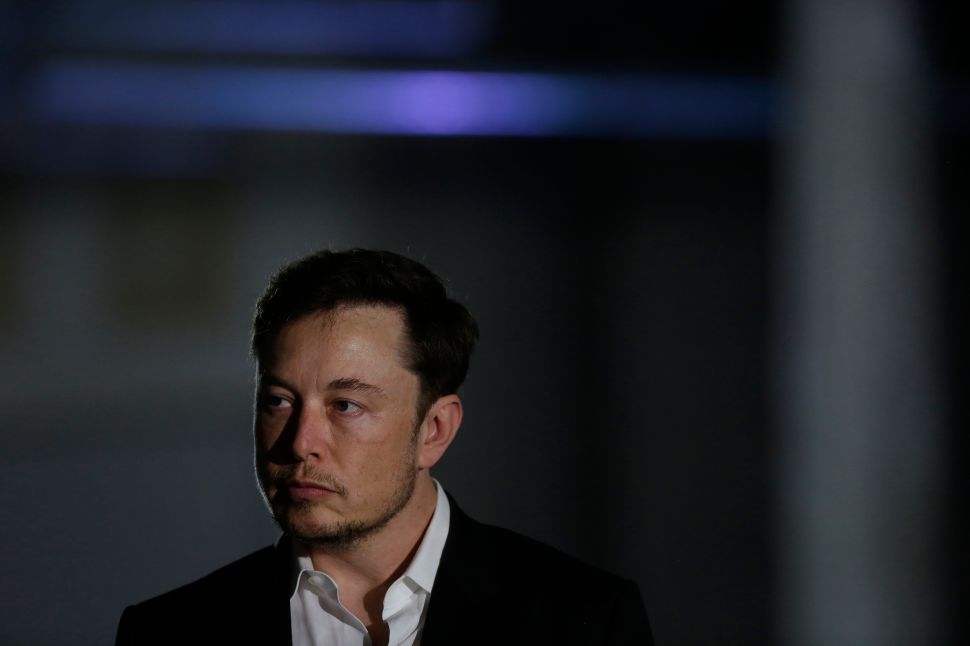 CHICAGO, IL - JUNE 14: Engineer and tech entrepreneur Elon Musk of The Boring Company listens as Chicago Mayor Rahm Emanuel talks about constructing a high speed transit tunnel at Block 37 during a news conference on June 14, 2018 in Chicago, Illinois. Musk said he could create a 16-passenger vehicle to operate on a high-speed rail system that could get travelers to and from downtown Chicago and O'hare International Airport under twenty minutes, at speeds of over 100 miles per hour.