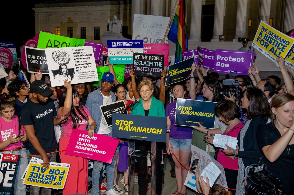 Senator Elizabeth Warren (D-Mass.) speaks to protesters in front of the U.S. Supreme Court.