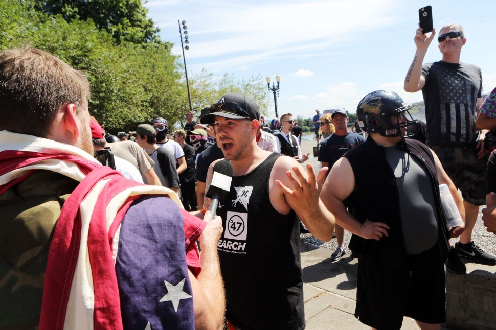 A man is interviewed by InfoWars at a campaign rally in Portland, Oregon, August 4, 2018.
