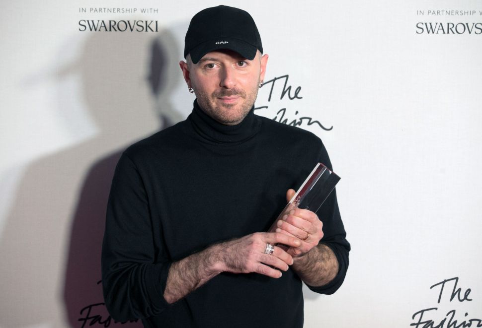 Designer Demna Gvasalia of fashion house Balenciaga poses with his award after being named winner of the International Ready-to-Wear Designer award during the British Fashion Awards 2016.