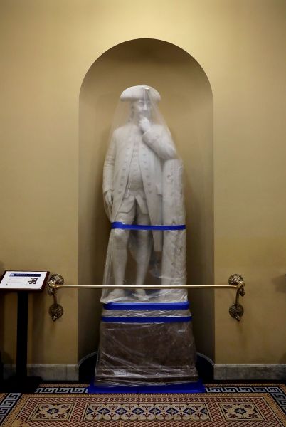 A statue of Benjamin Franklin wrapped in during a test of the U.S. Capitol's new smoke control system. 