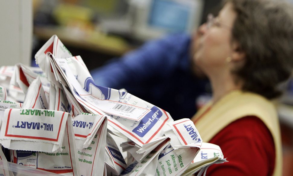 Filled prescription are stacked for sorting inside a Wal-Mart pharmacy.