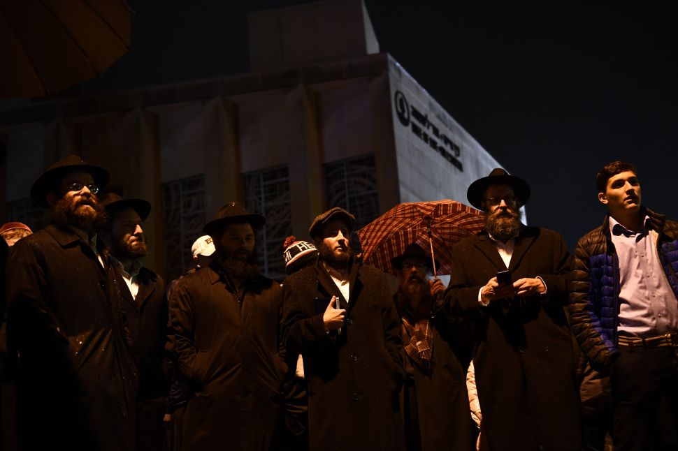 People gather outside the Tree of Life Synagogue in Pittsburgh after a shooting on Saturday that killed 11 people and injured six more in the deadliest anti-Semitic attack in recent American history.