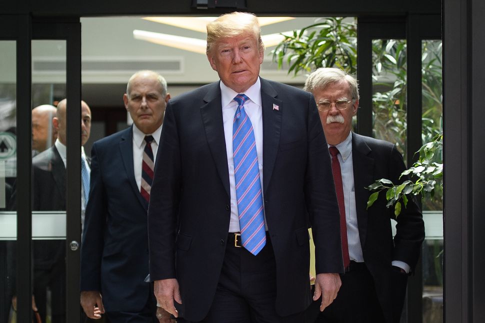 President Donald Trump with Chief of Staff John Kelly and National Security Advisor John Bolton.