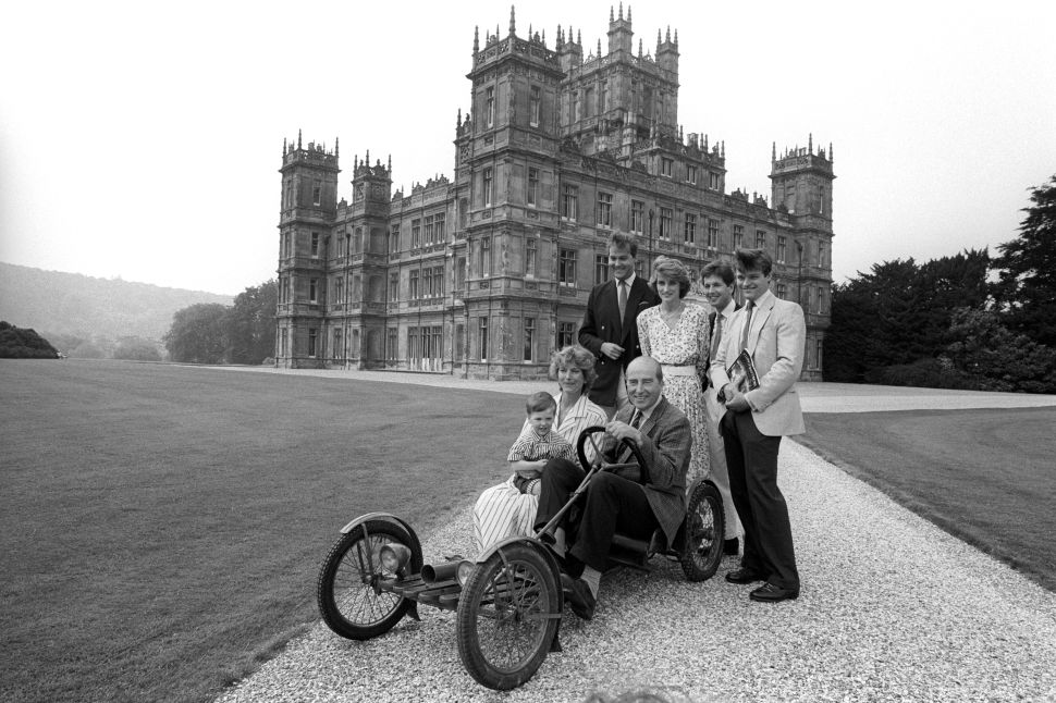 Lord Carnarvon (right) and his father Henry Carnarvon, seventh Earl of Carnarvon (middle), sitting in the 1922 family Red Bug Buckboard circa 1980.
